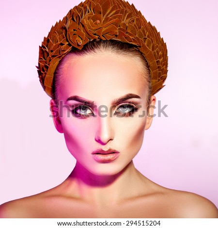 Square serious adult woman with makeup and wreath in studio