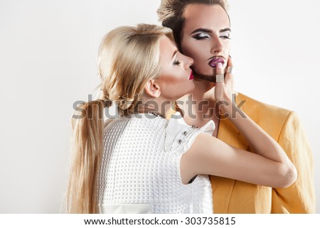 Gorgeous couple in love. both with nice makeup. Studio shot. horizontal. Grey background