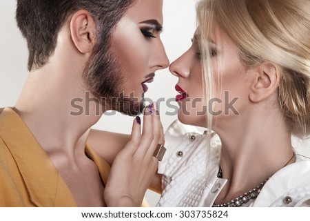 Couple in love kissing. Both with makeup. Passion. Seduction. Studio shot. horizontal.