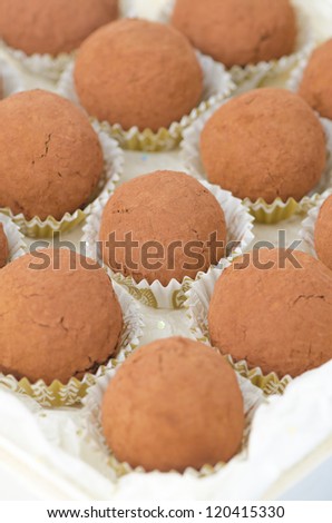 box of chocolate truffles closeup, selective focus on center