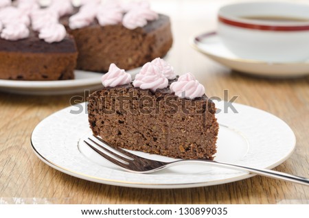 piece of chocolate cake with nuts on a plate horizontal