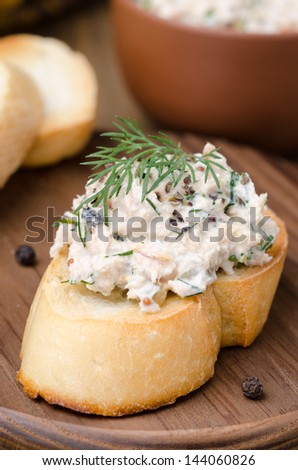 pate of smoked fish with sour cream and dill on toasted bread, vertical closeup