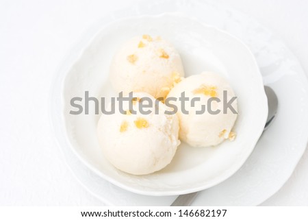Ginger ice cream with melted milk, top view close-up