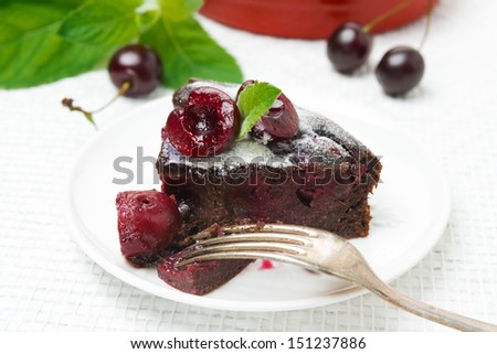 piece of chocolate Clafoutis with cherries and powdered sugar, close-up horizontal