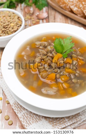 plate of vegetable soup with lentils, top view, vertical