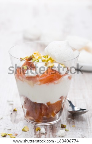 dessert with canned peaches, whipped cream and meringue, close-up, vertical