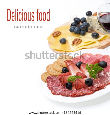 assorted deli meats, plate of cheese and a glass of wine, isolated on white