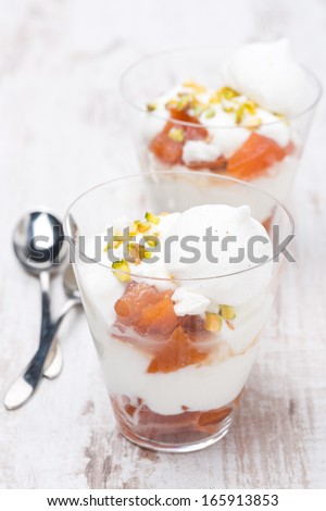 dessert with peaches, whipped cream and meringue, vertical