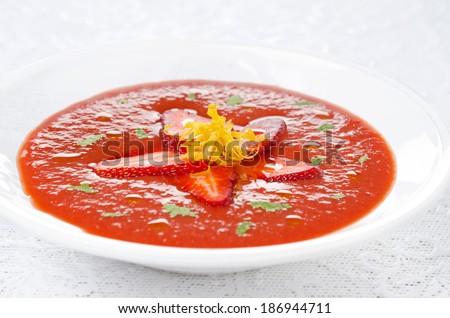 tomato and strawberry gazpacho in a plate, horizontal close-up