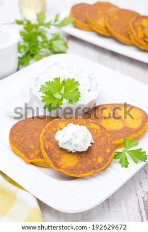 pumpkin pancakes with feta cheese sauce, vertical, top view