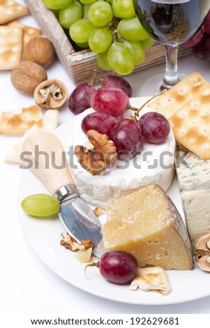 assortment of cheeses, glass of red wine, grapes and crackers, vertical