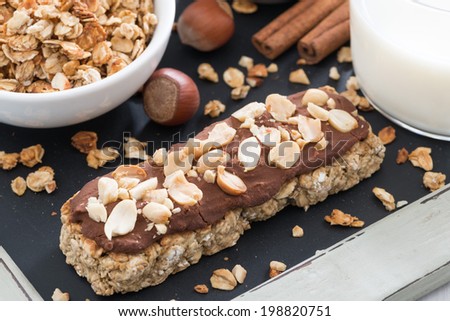 oat bar with chocolate and nuts, close-up, top view