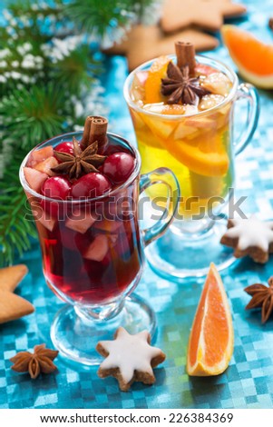 Christmas mulled wine and spiced apple cider on a blue background, vertical, close-up