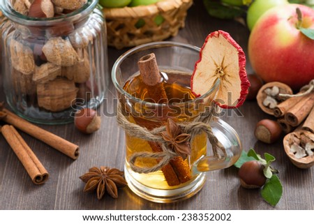 apple cider with spices in glass mug, top view, horizontal