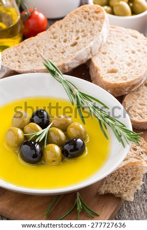 fresh olive oil and Italian snacks, vertical, close-up