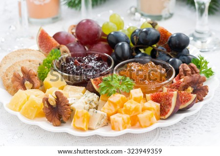 delicious cheese and fruit plate to the holiday, closeup