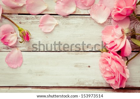 Romantic floral frame background/ Valentines day background/Pink roses on wooden background