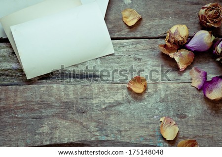 dried  roses with old letters on wooden background/ nostalgic romantic background