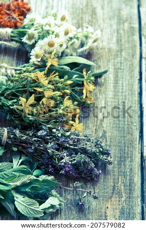 Fresh herbs on wooden surface with retro filter effect