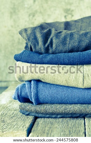 Pile of clothes on a wooden background