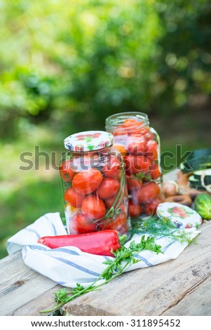 Homemade tomatoes preserves in glass jar. Canned tomatoes.