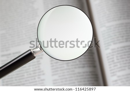 Classic style magnifying glass focusing on the book, concept of searching for answer, solution or knowledge. use as background and enter your text on the glass.