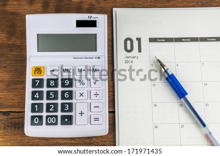January organizer with calculator & pen: concept for monthly budget.