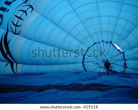 balloon, man walking inside a blue hot air balloon
