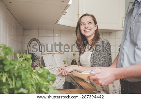 Young woman washing dishes in the kitchen