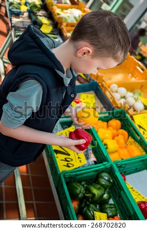 Boy holding fresh vegetables from the harvest