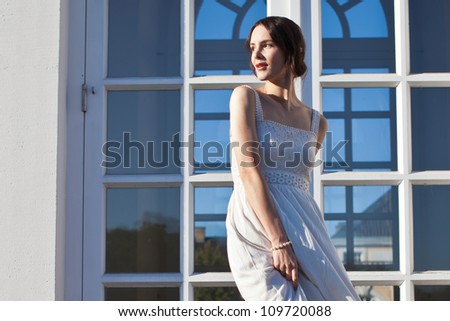 Beautiful woman in front of House Facade