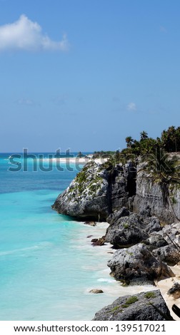 Blue Caribbean sea with white sand cliffs boat people Mexico
