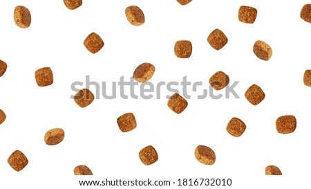 Dog food flying around poured in different directions on a white background.