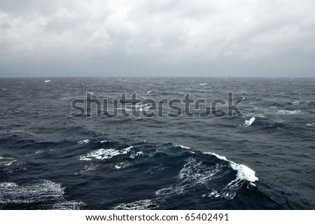 Deep sea water waves and stormy sky.