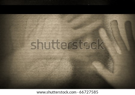 Distorted male figure behind flickering television screen. Static noise signal.