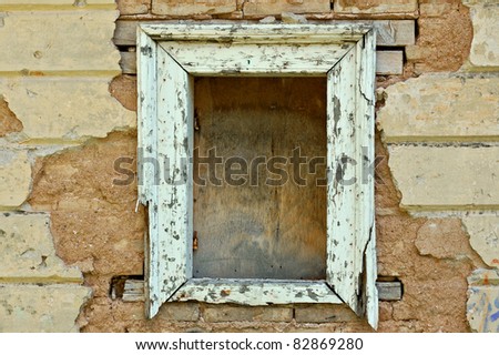 Empty wooden window frame and chipped wall texture. Grunge background.