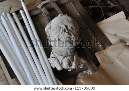 ATHENS - FEBRUARY 3: Broken sculpture head of adult man among debris in the abandoned studio of sculptor Nikolaos Pavlopoulos, Athens Greece, February 3, 2012.