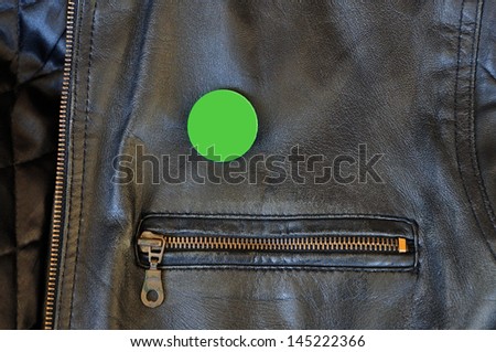 Black leather jacket with zipper and blank pin badge to add your own text or logo.