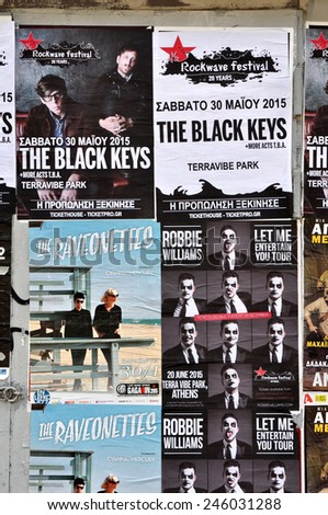 ATHENS, GREECE - JANUARY 16, 2015: City wall covered with concert posters for upcoming live music shows by The Black Keys, Raveonettes and Robbie Williams.