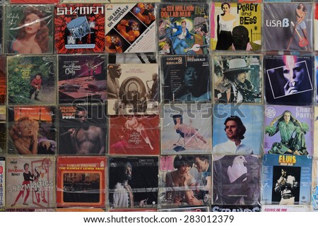 ATHENS, GREECE - APRIL 24, 2015: Wall with old vinyl records vintage music lp album covers in plastic sleeves background.