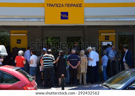 ATHENS, GREECE - JULY 1, 2015: Crowd of people queue at Piraeus bank one of the few branches open to the public only for pensioners without ATM cards to withdraw part of their pension in cash money.