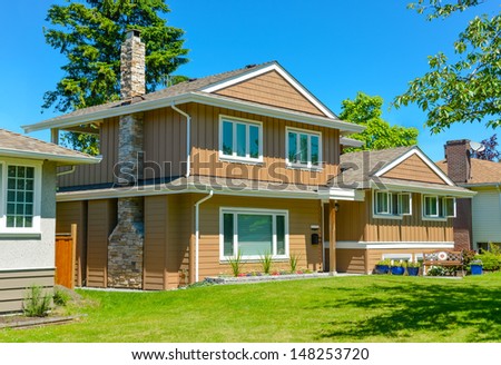 Family house in suburban area of Vancouver, Canada. North American house on blue sky background on a sunny day
