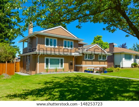 Family house in suburban area of Vancouver, Canada. North American house on blue sky background on a sunny day
