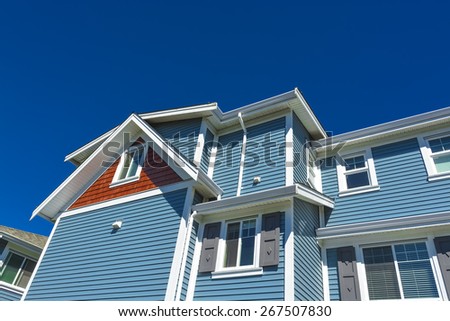New residential townhouse on sunny day on blue sky background. British Columbia, Canada.