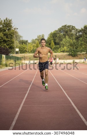 Runner on a track. Frontal full body shot.