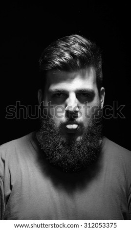 Funny portrait of men with his tongue out. Serious face expression, black eyes.