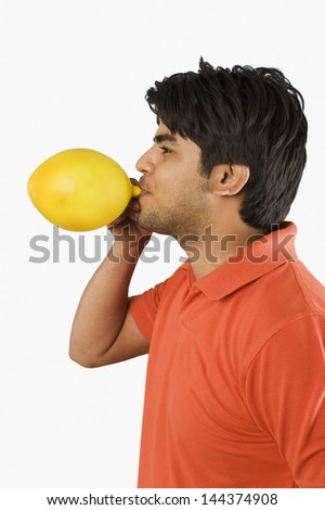 Man blowing up a balloon