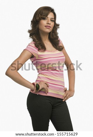 Fashion model standing with arms akimbo