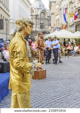 BUCHAREST, ROMANIA - JULY 13, 2014: Free cultural program and live statue artists in Old town streets of Bucharest during summer.
