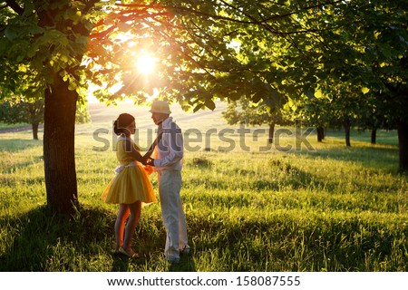 man and woman in sunset inthe park